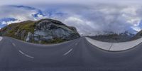 this is a fish eye view of the street of some sort with the mountains in the background