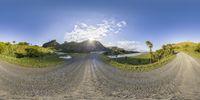 a split view shot of the road leading to a body of water and a grassy hill