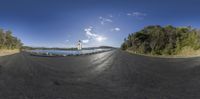 360 - view shot of the landscape of the road near a small church and a body of water