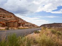 a scenic and scenic landscape of rocks and canyons with a highway below it on a cloudy day