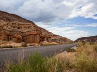 a scenic and scenic landscape of rocks and canyons with a highway below it on a cloudy day