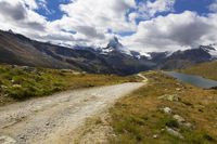 Scenic Landscape in Switzerland: A Dirt Road Amidst Mountains