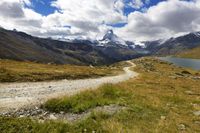 Scenic Landscape in Switzerland: A Dirt Road Amidst Mountains