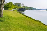 Scenic Landscape with Water, Grass, and Trees in Thailand