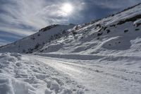 snow is on the road in front of the sun, with no one in sight