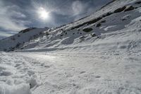 snow is on the road in front of the sun, with no one in sight