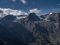 a mountain with some very pretty mountains in the background taken by a person in the foreground