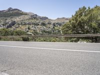 a bike is shown in the view while driving down a mountain road past some trees