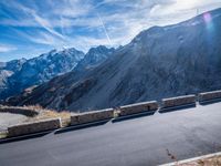 a mountain road running alongside the top of snowy mountains in switzerland and france at the same time