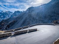 a mountain road running alongside the top of snowy mountains in switzerland and france at the same time