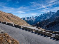 a mountain road running alongside the top of snowy mountains in switzerland and france at the same time