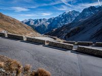 a mountain road running alongside the top of snowy mountains in switzerland and france at the same time