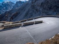 a mountain road running alongside the top of snowy mountains in switzerland and france at the same time