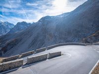 a mountain road running alongside the top of snowy mountains in switzerland and france at the same time