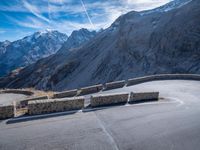 a mountain road running alongside the top of snowy mountains in switzerland and france at the same time