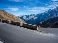 a mountain road running alongside the top of snowy mountains in switzerland and france at the same time