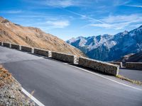 a mountain road running alongside the top of snowy mountains in switzerland and france at the same time