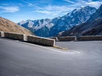 a mountain road running alongside the top of snowy mountains in switzerland and france at the same time