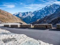 a mountain road running alongside the top of snowy mountains in switzerland and france at the same time