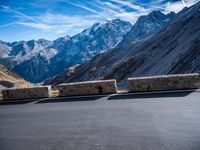 a mountain road running alongside the top of snowy mountains in switzerland and france at the same time