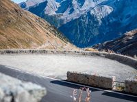 a mountain road running alongside the top of snowy mountains in switzerland and france at the same time