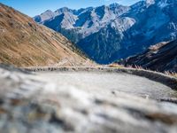 a mountain road running alongside the top of snowy mountains in switzerland and france at the same time