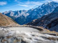 a mountain road running alongside the top of snowy mountains in switzerland and france at the same time