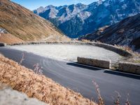 a mountain road running alongside the top of snowy mountains in switzerland and france at the same time
