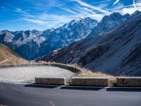a mountain road running alongside the top of snowy mountains in switzerland and france at the same time
