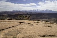 the view from atop the rock trail in a desert mountain range with mountain views visible in the distance