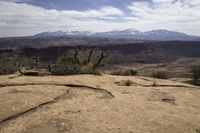 the view from atop the rock trail in a desert mountain range with mountain views visible in the distance