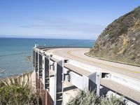 the view from behind the highway overlooks at a mountain near an ocean shoreline area