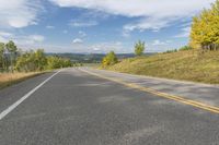 a scenic scenic country road winding towards a scenic mountain area with pine trees on either side