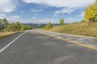 a scenic scenic country road winding towards a scenic mountain area with pine trees on either side