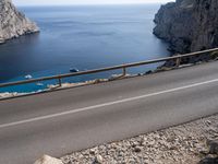 a motorcycle is parked on the road near the ocean and mountainside in turkey on an autumn day