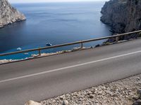 a motorcycle is parked on the road near the ocean and mountainside in turkey on an autumn day