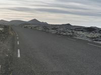 a bike is in the middle of a road in the middle of a barren desert