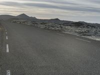 a bike is in the middle of a road in the middle of a barren desert