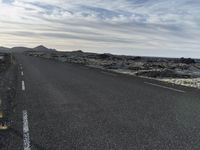 a bike is in the middle of a road in the middle of a barren desert