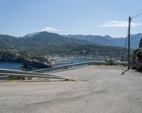 there is a mountain view as if looking down on a road with mountains in the back ground