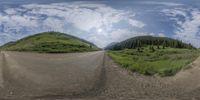 a fisheye lens view of a road in the distance with trees on both sides