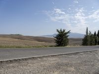 there is a person riding their bicycle down the road and a view in the background