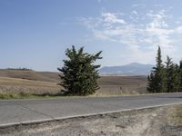 there is a person riding their bicycle down the road and a view in the background