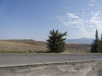 there is a person riding their bicycle down the road and a view in the background