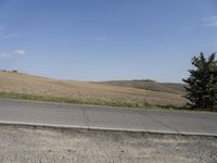 there is a person riding their bicycle down the road and a view in the background