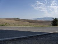 there is a person riding their bicycle down the road and a view in the background