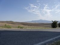 there is a person riding their bicycle down the road and a view in the background