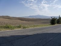 there is a person riding their bicycle down the road and a view in the background