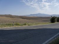 there is a person riding their bicycle down the road and a view in the background