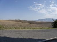 there is a person riding their bicycle down the road and a view in the background